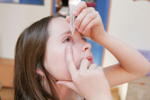 CHILD USING EYE LOTION